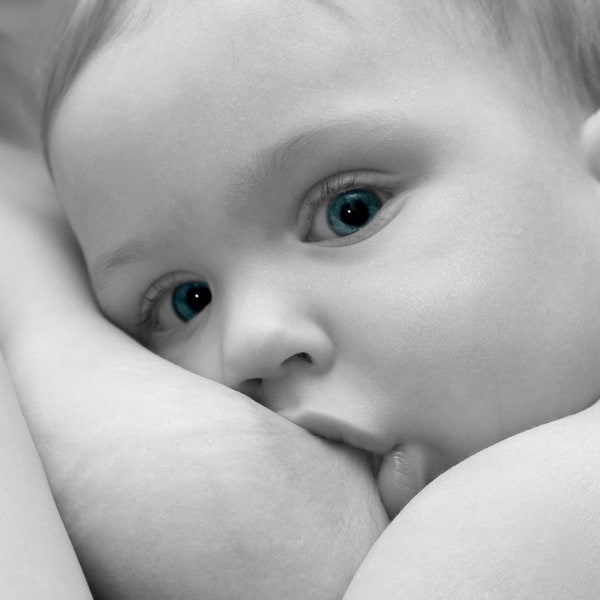 A newborn baby breastfeeding
